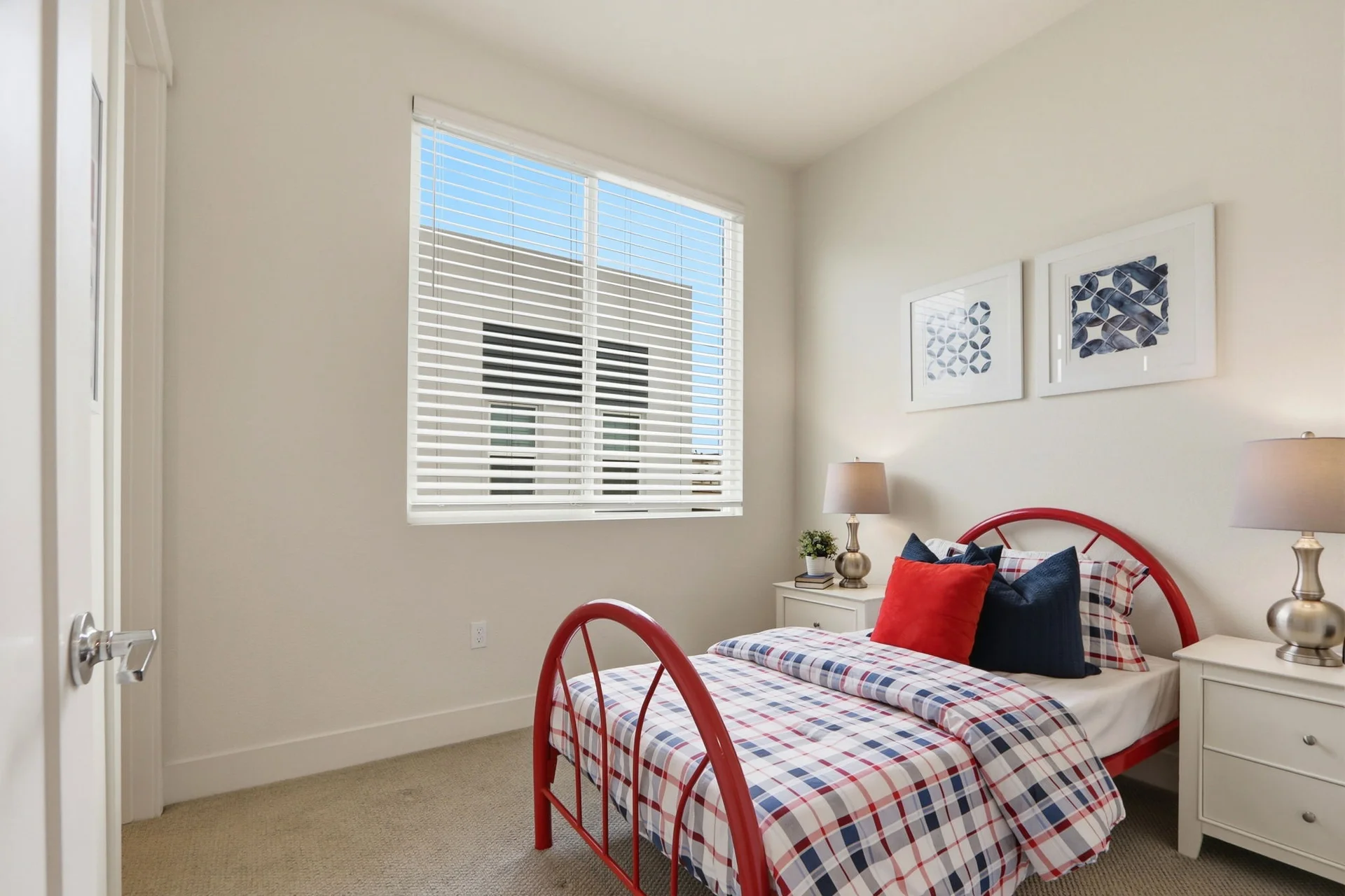 Bedroom with red bed frame and window light