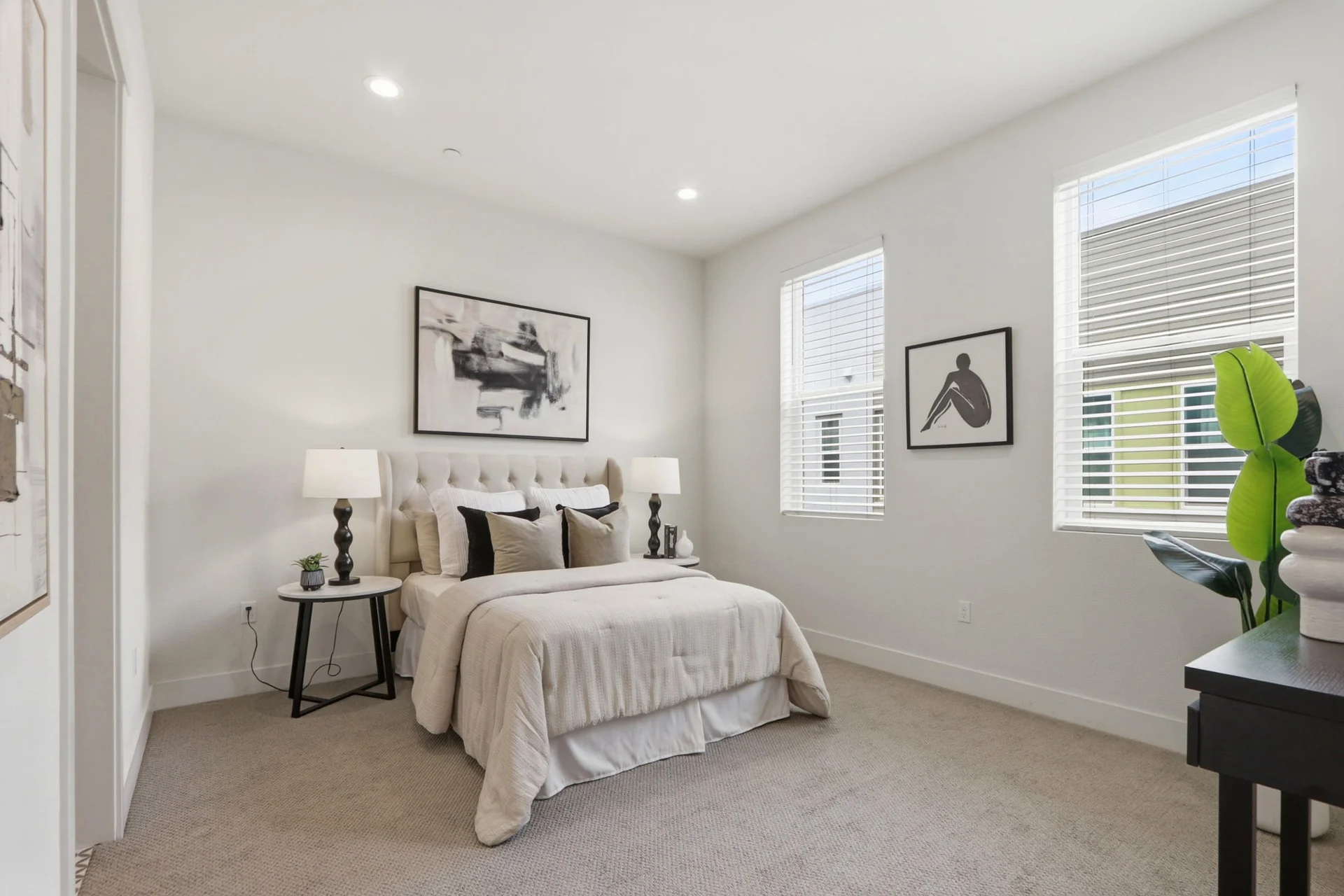 Guest bedroom with two windows and neutral bedding