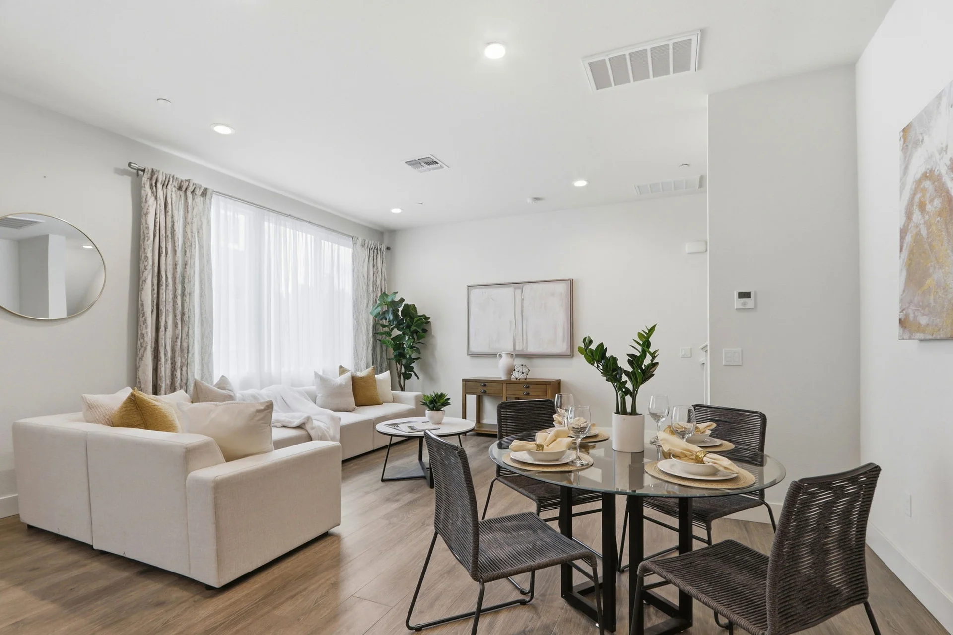Living area and glass dining table by the window wall