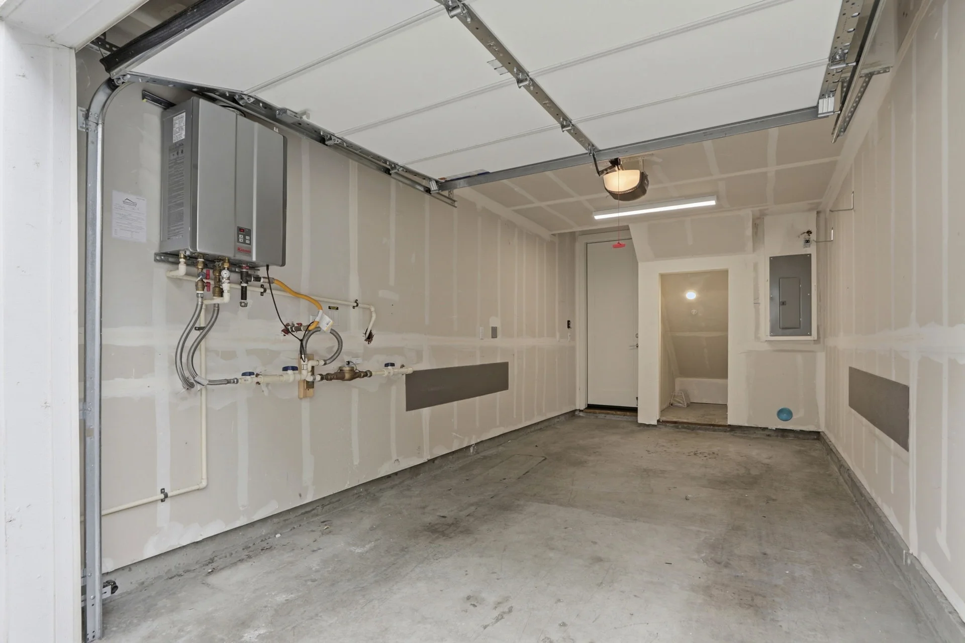 The attached one-car garage, finished, with tankless water heater