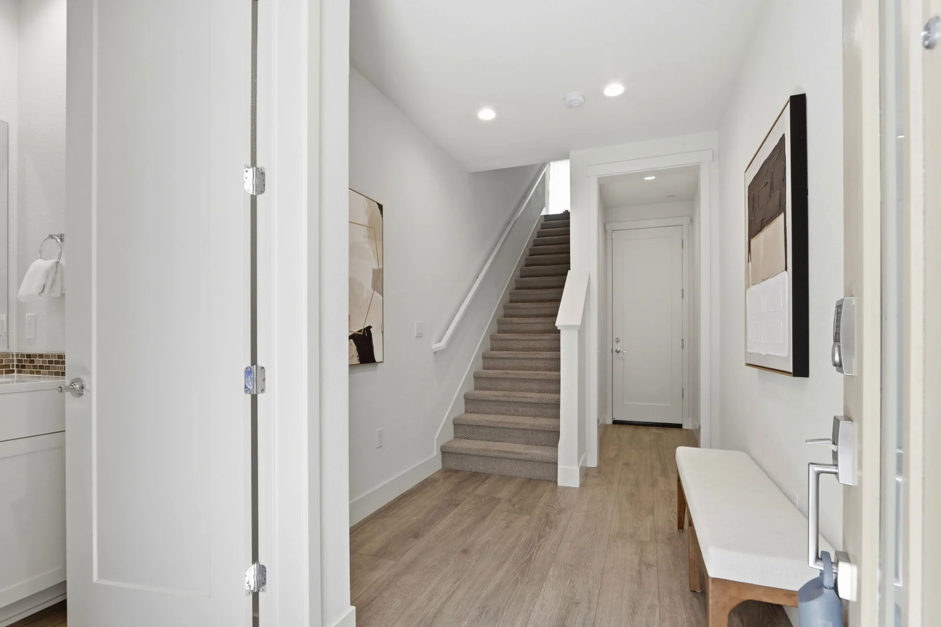 Entry hall with bench and the stair to the main level